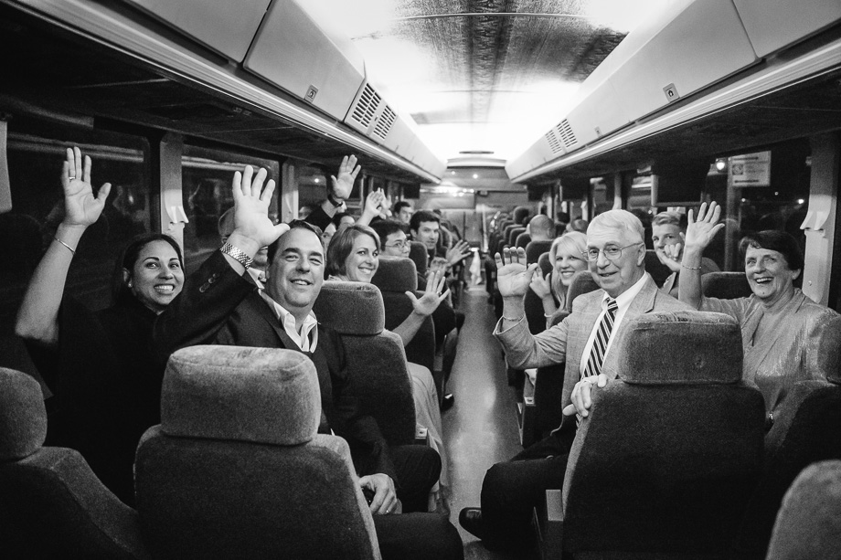 a surprise photo for the bride and groom - family waving on a bus