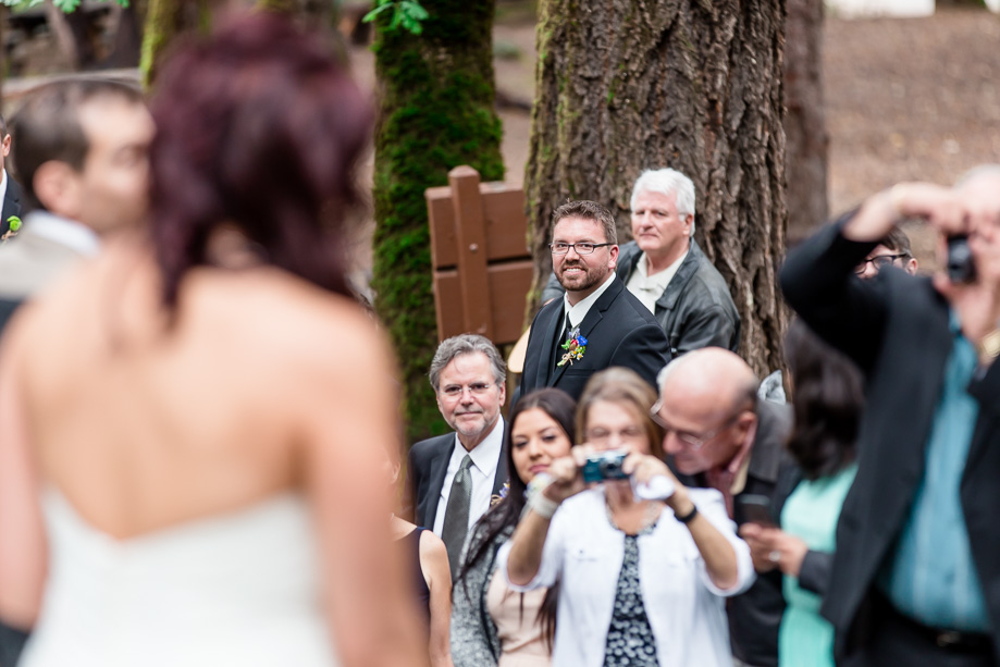 groom looking at his bride walking down the aisle at Uvas Canyon Park