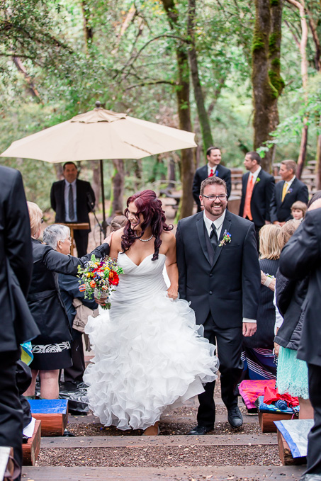bride and groom walking up the aisle after tying the knot