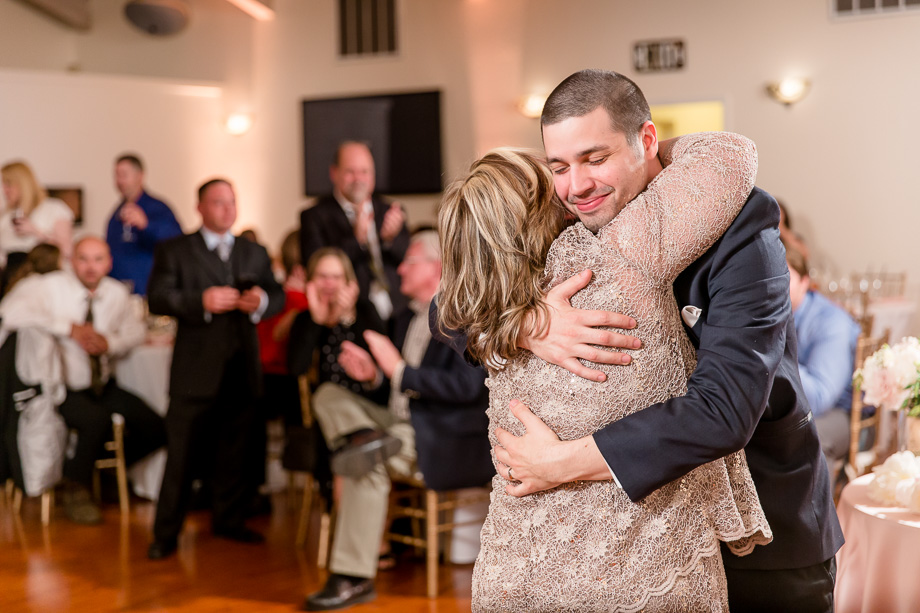 groom and mother giving each other a warm hug