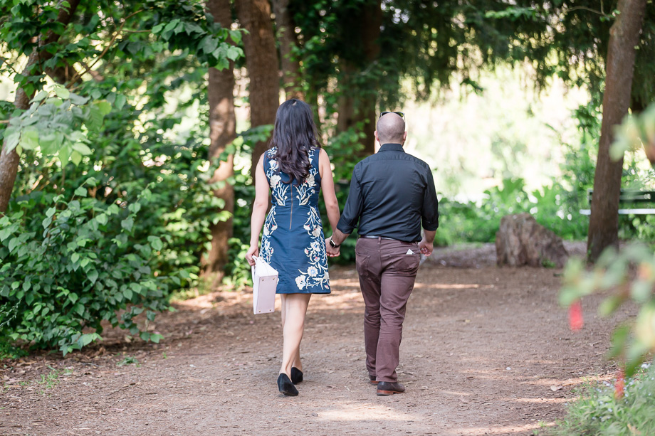 paparazzi stealthy photo of couple walking around Stow Lake