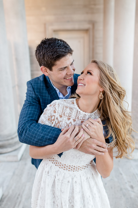 sweet couple look at each other at this beautifully sunlit hallway