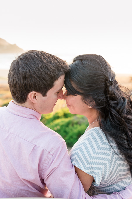 maternity photo on a bench overlooking pacific ocean