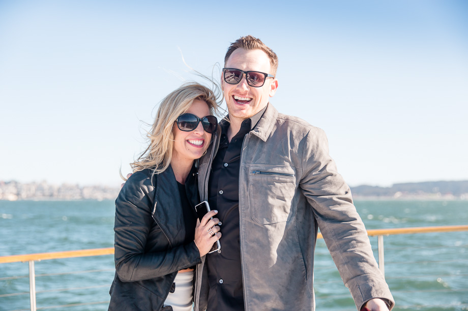 the happy couple right after their proposal on the yacht in front of San Francisco skyline
