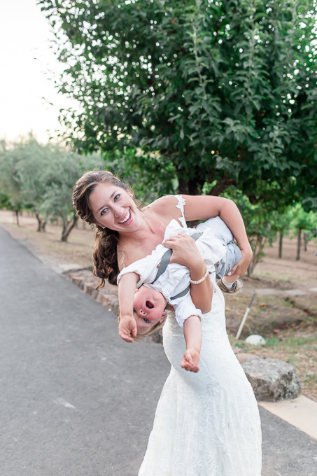 bride swinging the ring bearer