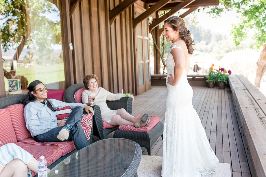 bride chatting with family at the balcony of the building that was designed by John Marsh Davis