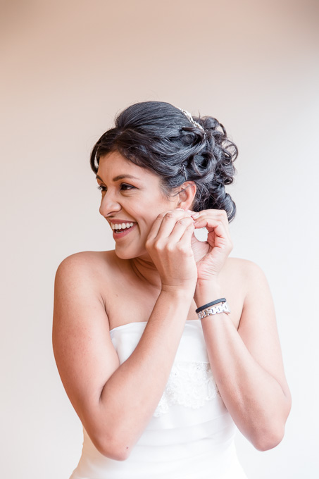 bride putting on her earrings
