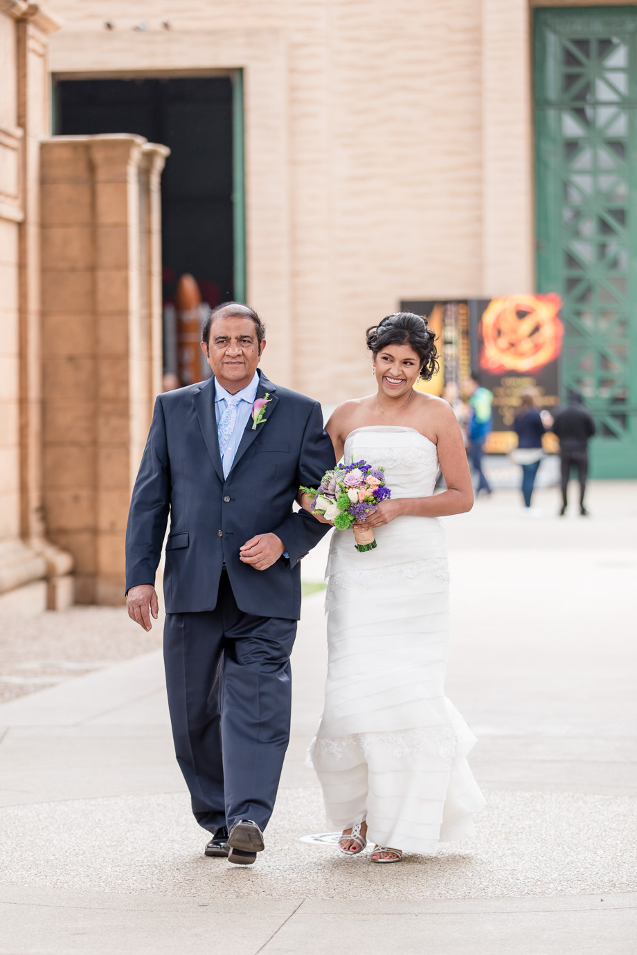 bride walking down the aisle escorted by father