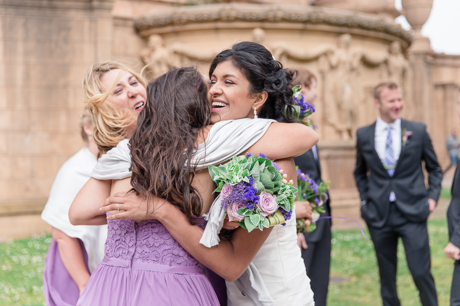 a warm hug with her bridesmaids after the ceremony