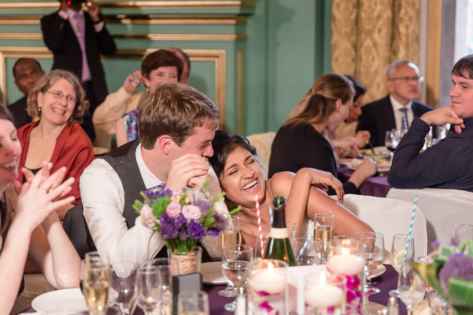bride and groom laughing at the best mans speech