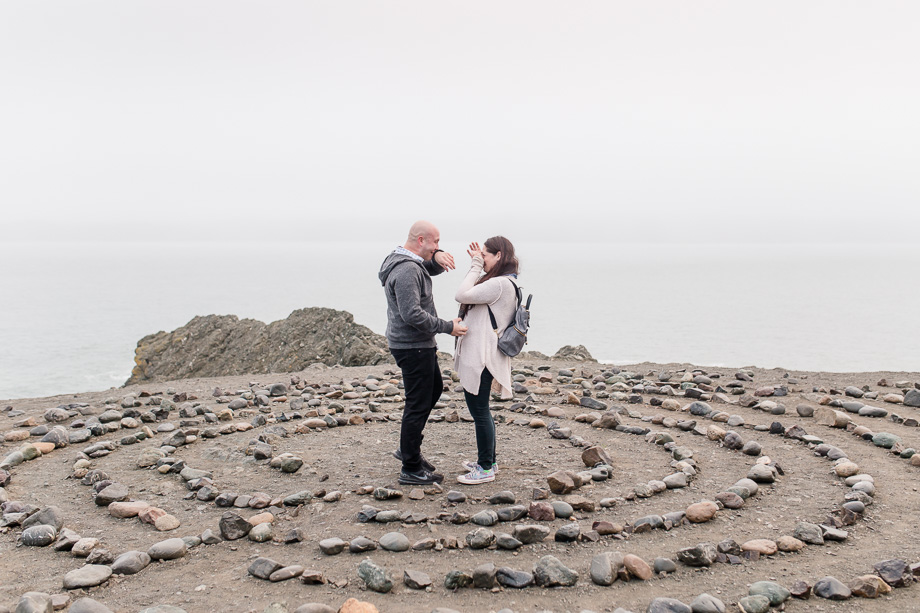 both wiping their tears after they got engaged on a foggy day in san francisco