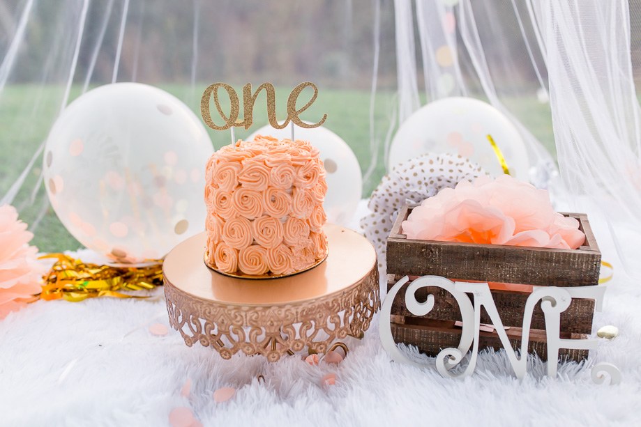 cute and pretty pastel decor for baby girl one year cake smash - white pink and gold