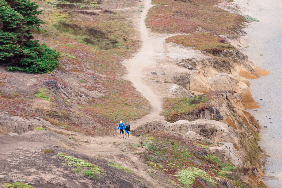 couple walking along the hiking trail by pacifica state beach