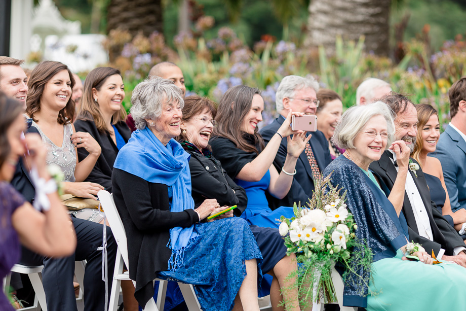 wedding guests laughing at the officiants funny speech