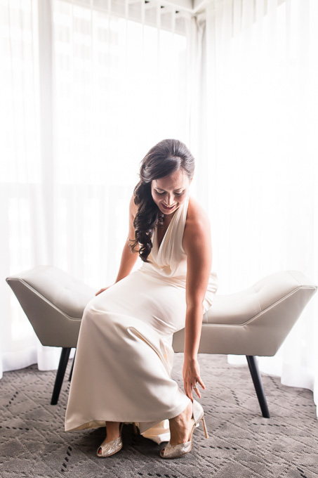 bride putting on her sparkly shoes to finish up her hollywood glam look
