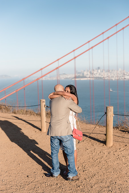 newly engaged couple hugging each other
