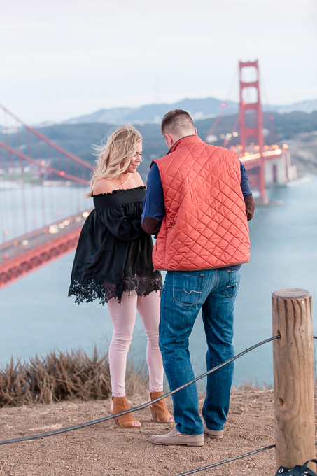 putting on the engagement ring for her