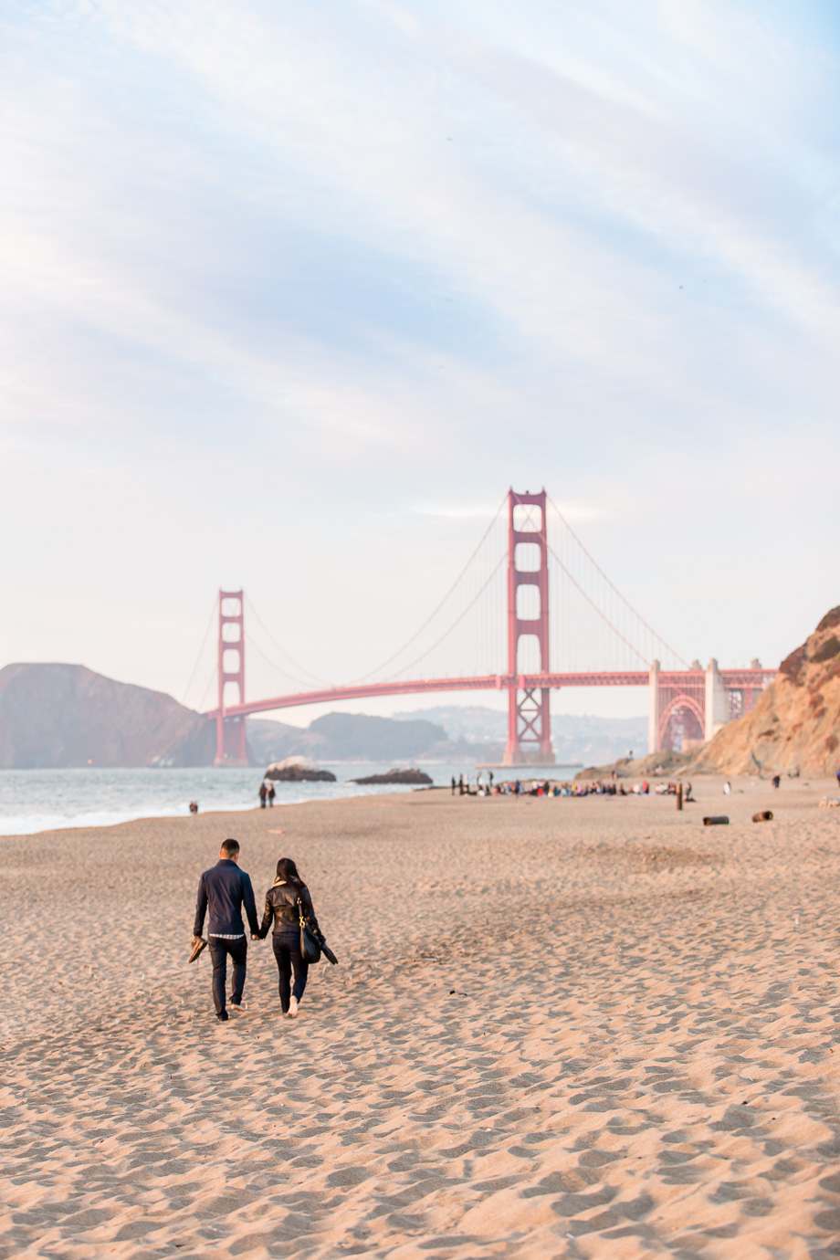 a candid paparazzi photo of this couple that is about to have their proposal happen here at the Baker Beach