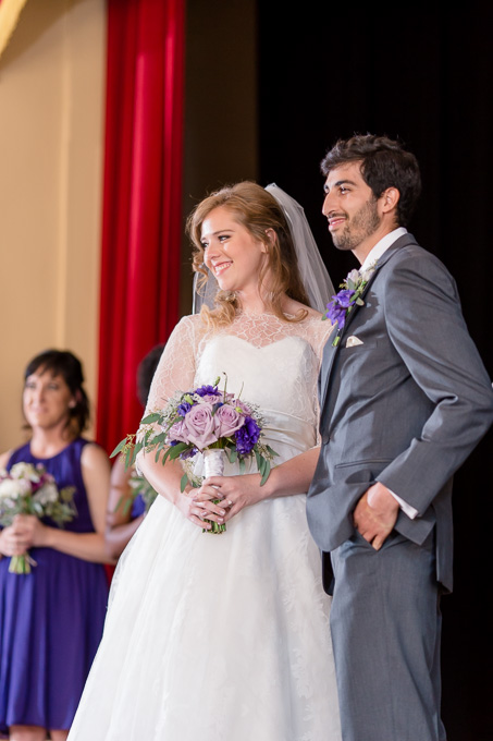 bride and groom receiving blessings from the wedding guests at the ceremony