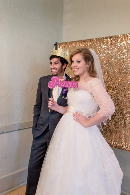 cute photo of bride and groom having fun at their wedding photo booth