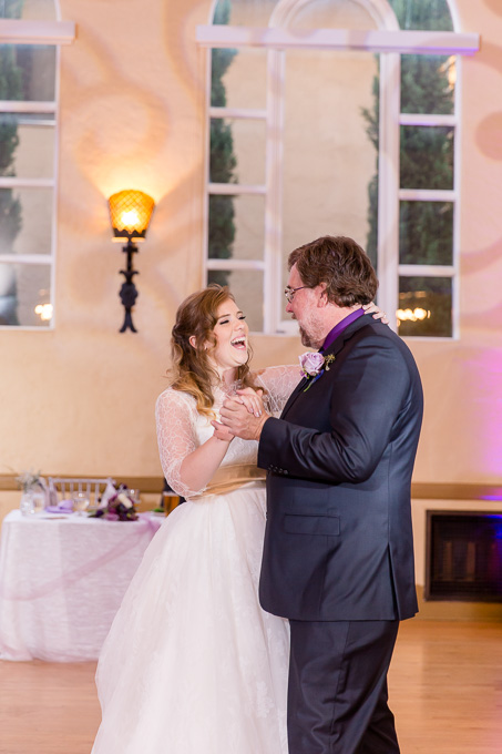 a happy bride dancing with her father