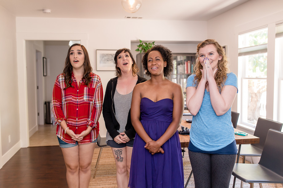 a first look with the bridesmaids after getting into her wedding dress