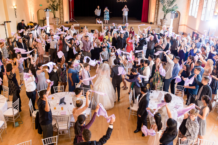 a surprise grand entrance into the reception hall where all the guests wave their napkins at the newlyweds