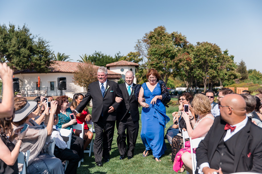 groom and parents walking down the aisle
