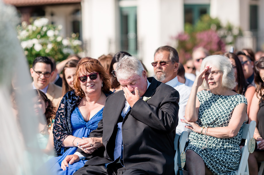 groom dad wiping away his tears at the ceremony