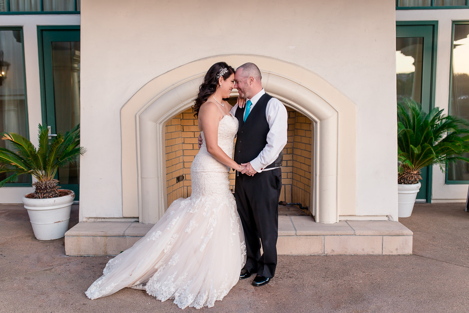 wedding photo in front of an outdoor fireplace