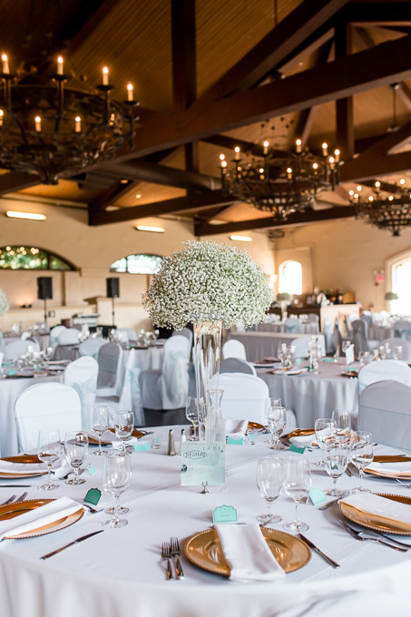 babys breath centerpieces with wood ceiling and gold plate settings
