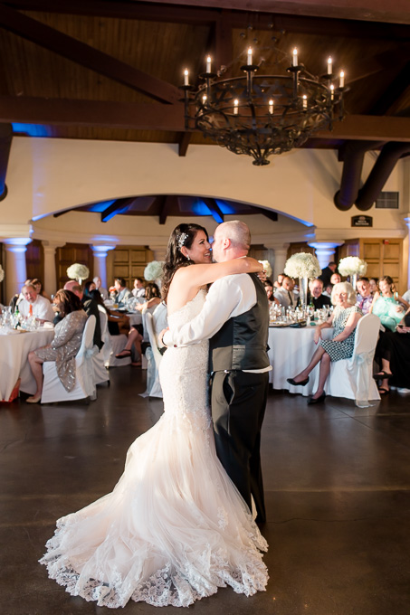 bride and groom first dance under the chandelier