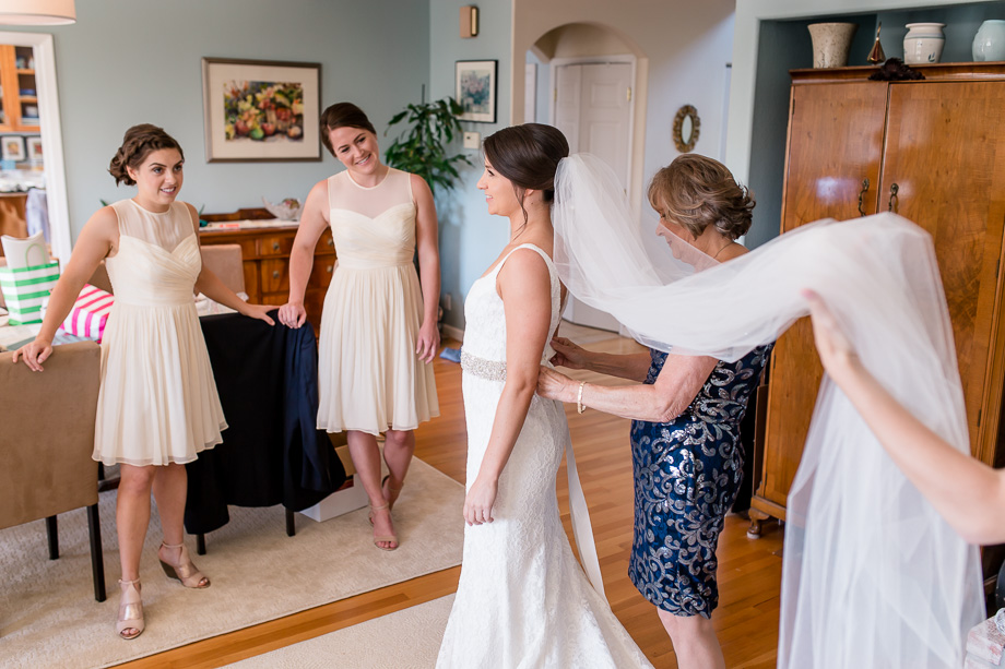 the bride stepped into her fitted wedding gown