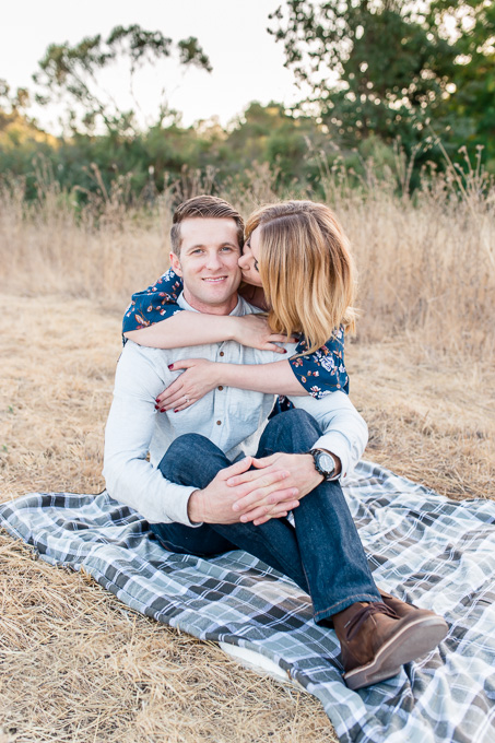 picnic engagement photo on golden grass