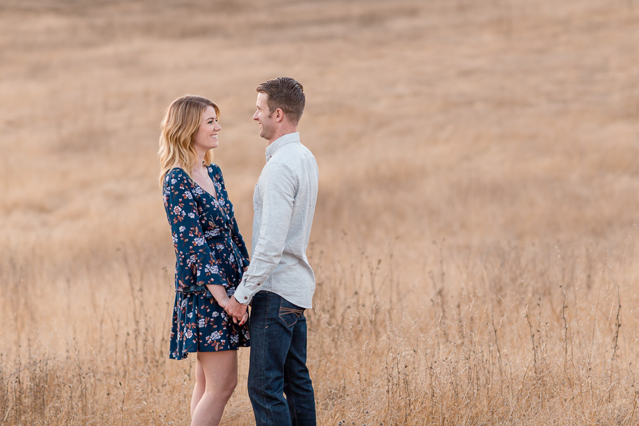 engagement photo at an open field with golden tall grass - san francisco wedding photographer