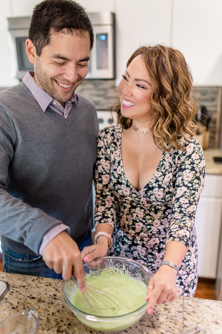 couple maing pancakes together in their kitchen