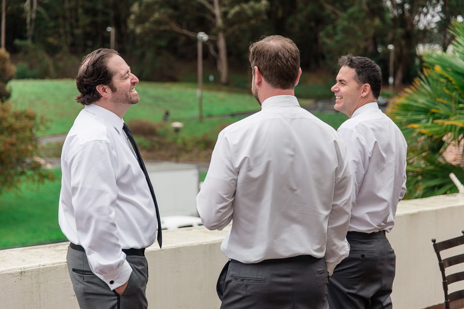 groom and groomsmen relaxing on the balcony