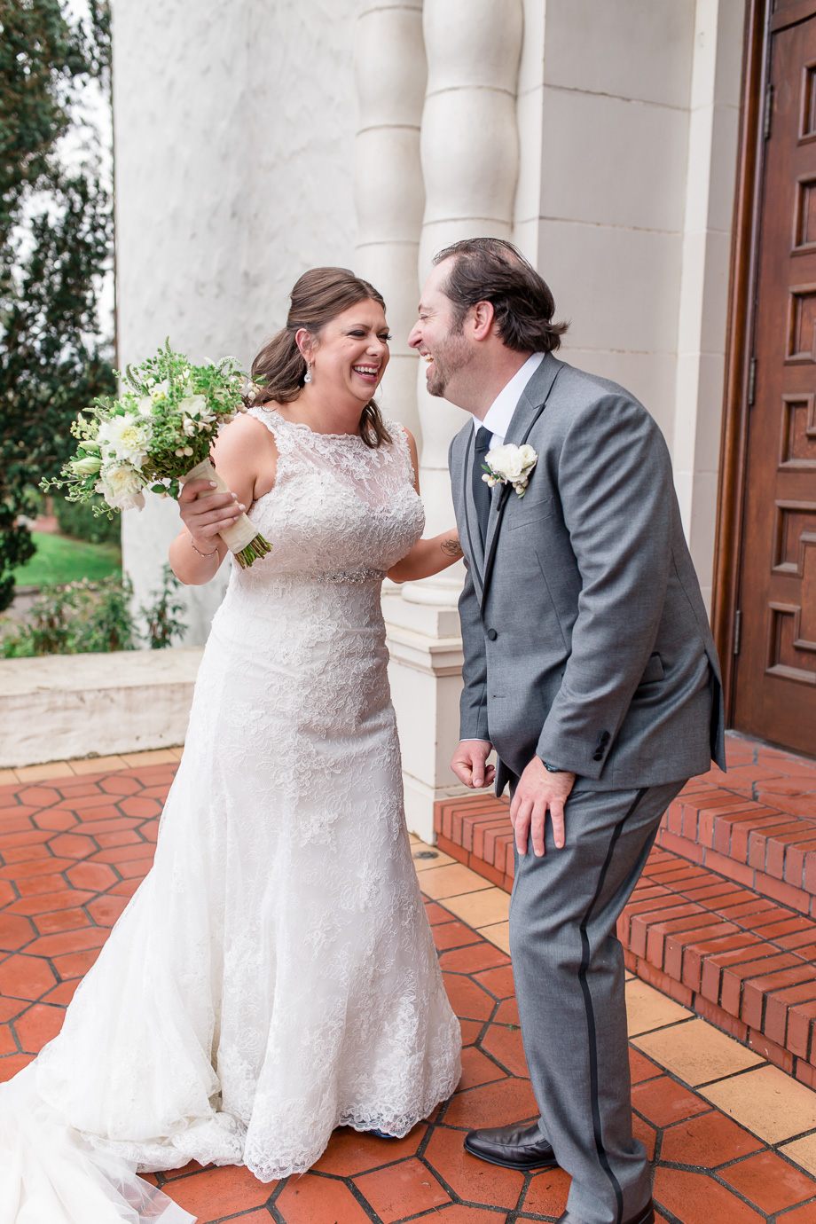 candid moment of the bride and groom laughing hard