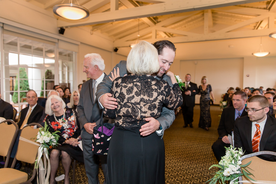 groom hugging his parents