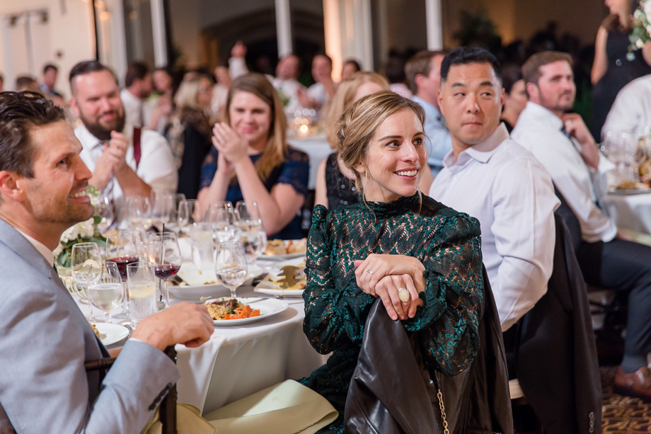 wedding guests enjoying the well written speeches at the reception