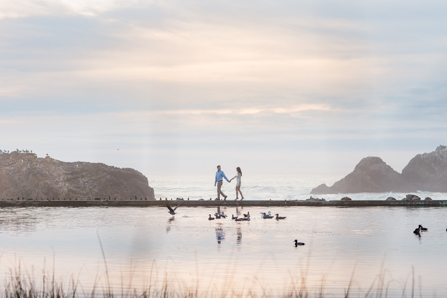couple walking under the dramatic skies