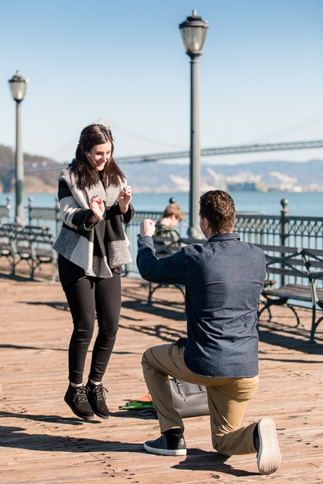 san francisco surprise emgagement proposal at the pier - jump for joy