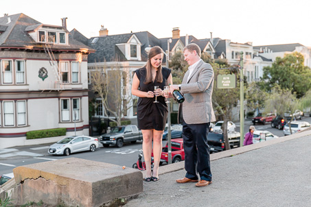 puring out champagne to celebrate engagement