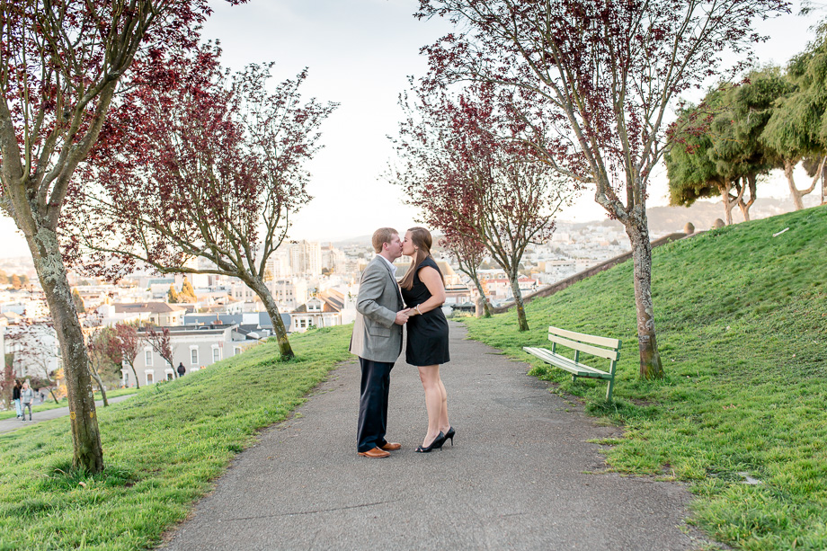sweet kiss under rows of red blooming trees
