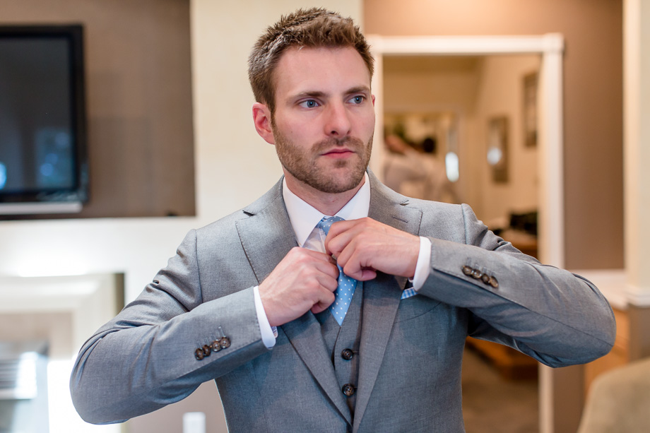 groom adjusting tie before the ceremony