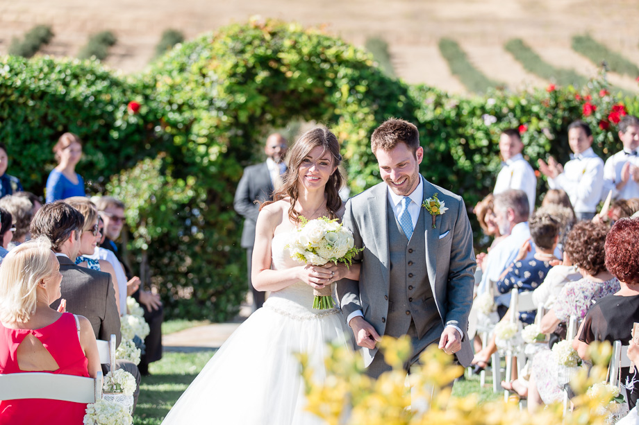 bride and groom walking down the aisle as husband and wife