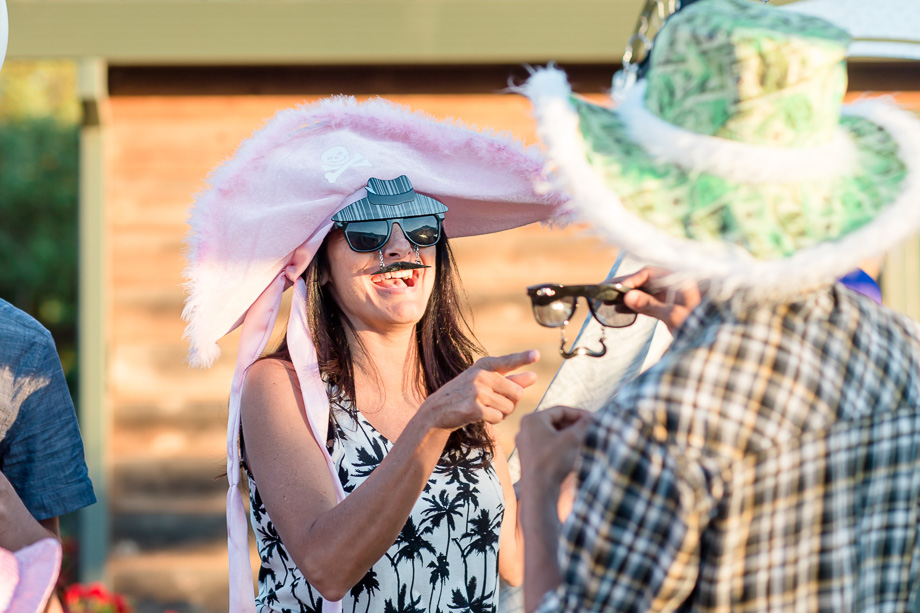 wedding guests enjoying the fun props at the photobooth