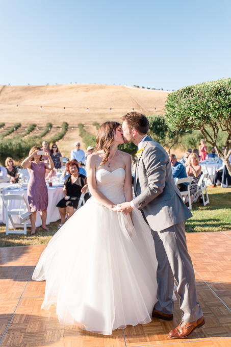 a romantic kiss after their first dance - purple orchid spa and resort wedding