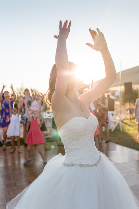 outdoor bouquet toss during sunset