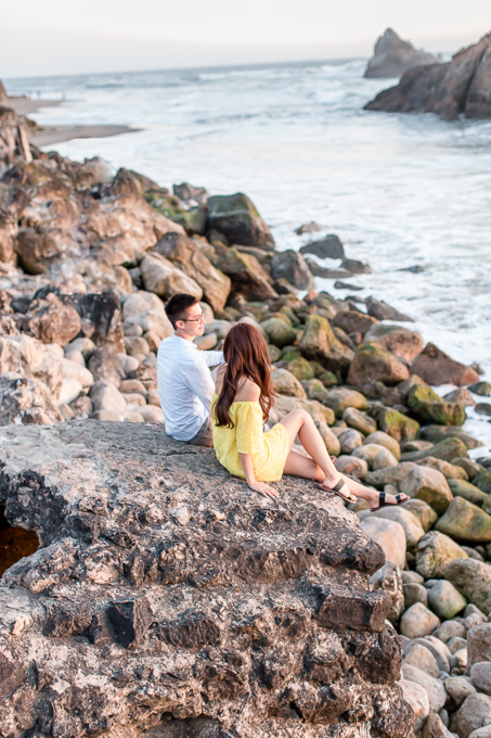 casual candid engagement photo by ocean rocks in san francisco
